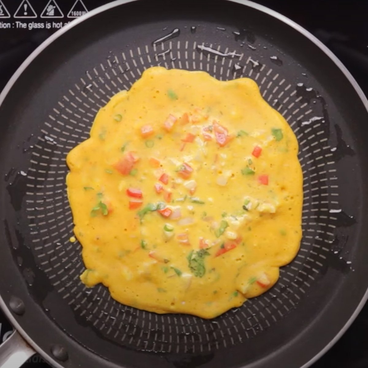 Poured the cheela batter in a pan to cook