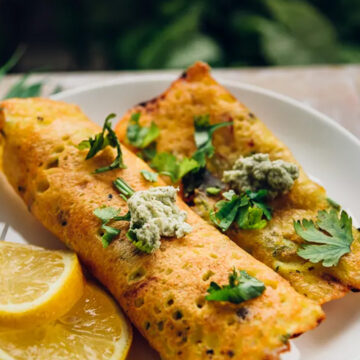 a dish served with lemon wedges in a plate