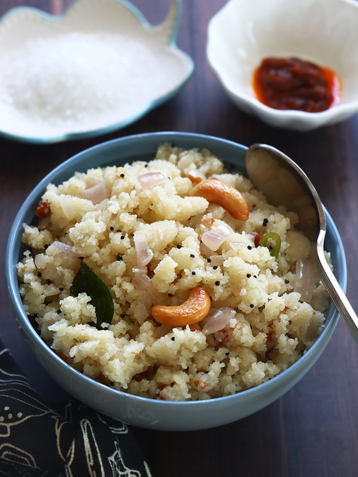 Upma served in a bowl with side dishes